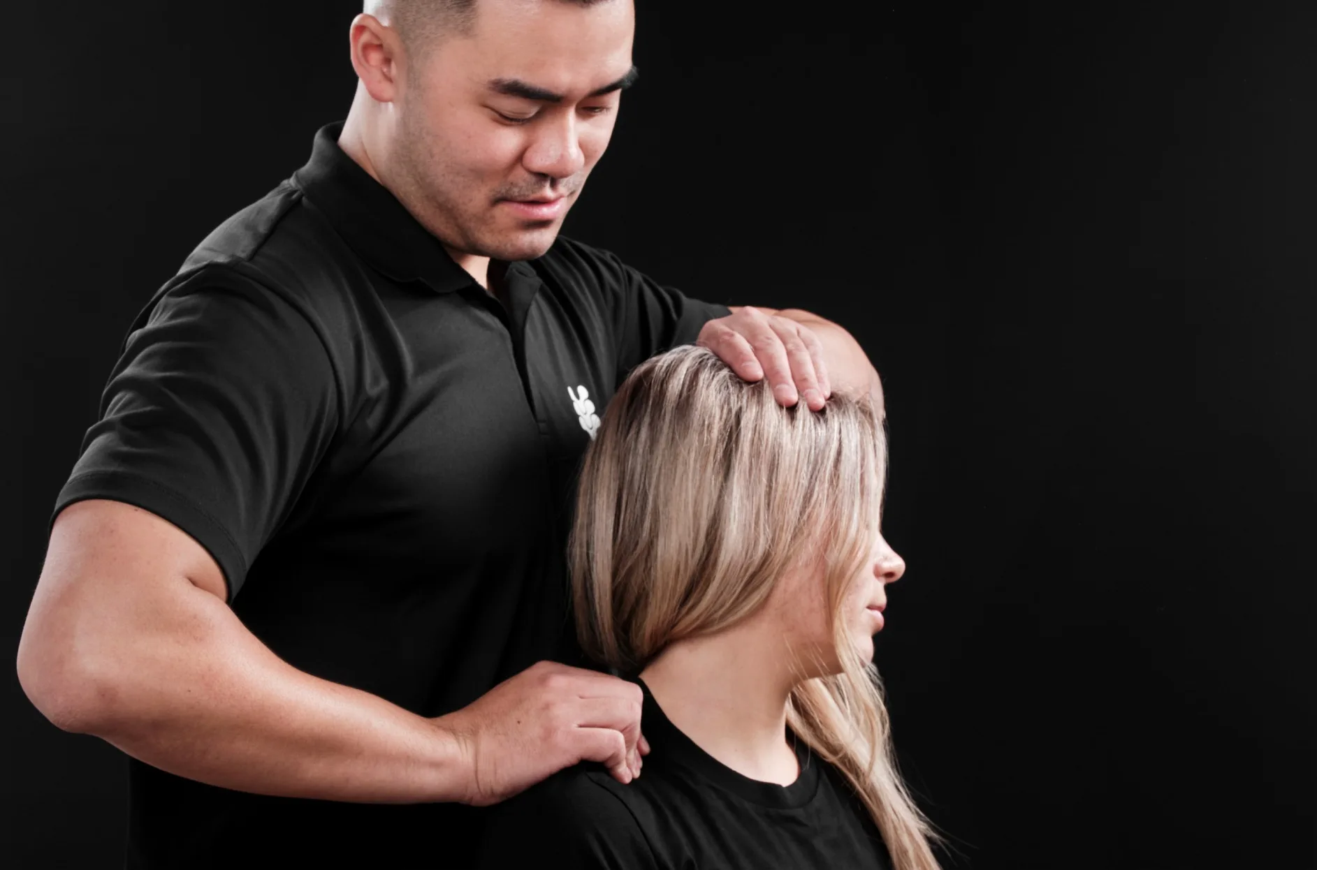 A practitioner assessing a client at The Spinal Studio